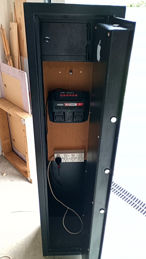 The picture shows a gun safe configured as a battery charging station. The charger and power points are mounted inside on a plywood sheet and the door can be closed to contain the explosive fire of the battery when it blows up.