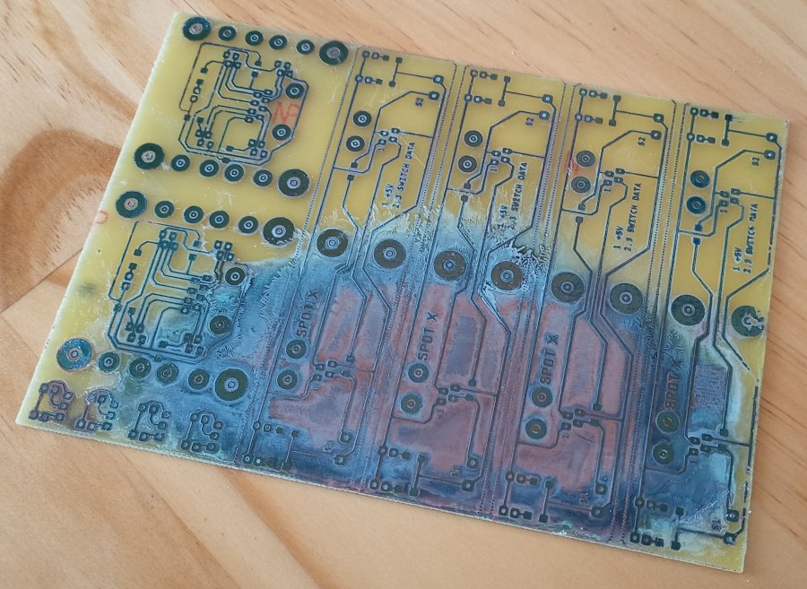 Picture of a homemade PCB. It is incompletely etched, meaning that although the design is visible, there is still a lot of corroded copper covering large sections of the board. The areas that are etched are poorly defined and the whole thing is an unmitigated catastrophe.