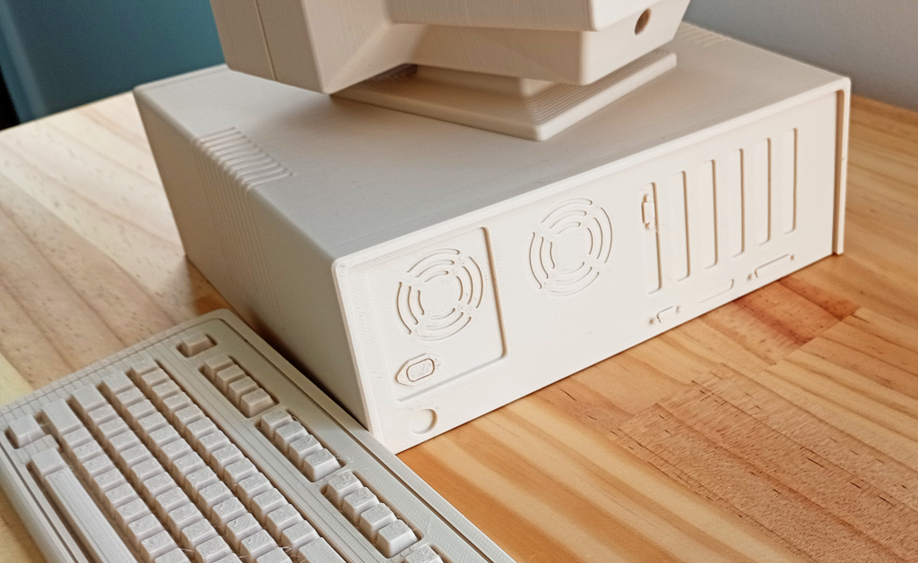 Rear view of the computer. Visible are the power supply and expansion card slots, actually just moulded into the plastic. The rear panel can slide out to access the inside of the case.