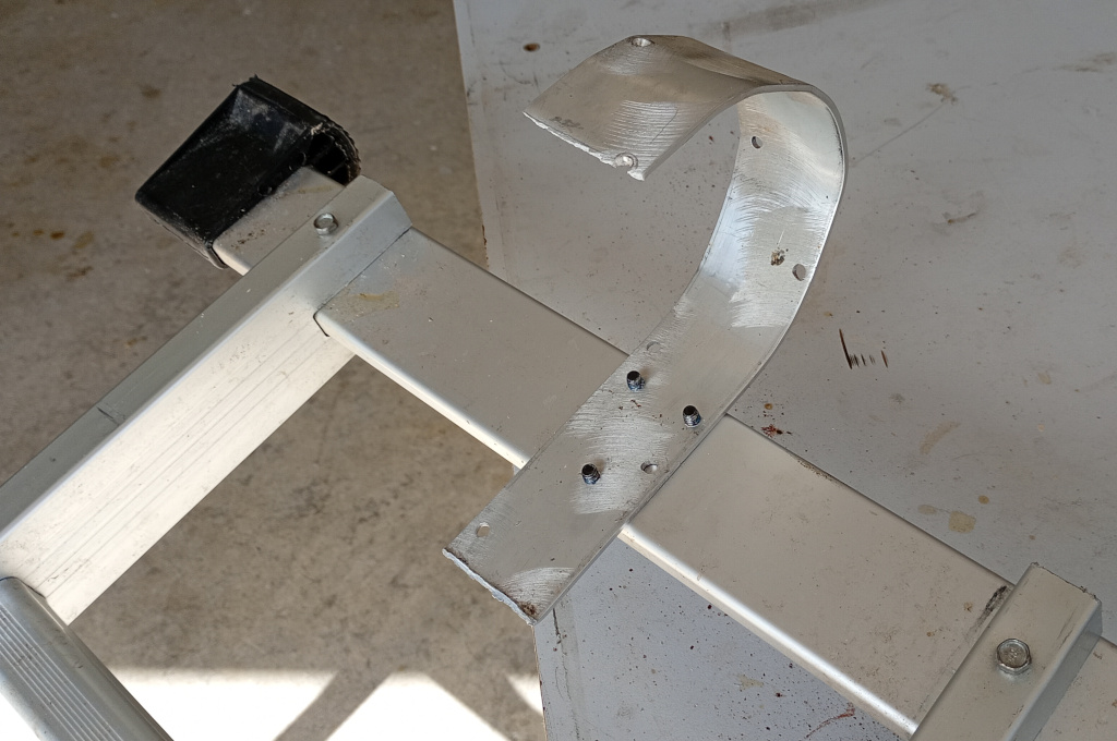 An aluminium ladder with a hook made from a length of 50 x 3 mm aluminium plate bolted onto the end.